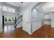 Bright foyer with hardwood floors, a staircase with black railings, and wainscoting, offering a grand entrance to the home at 3362 Palm Nw Cir, Kennesaw, GA 30144