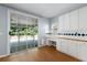 Eat-in kitchen with a sliding glass door, wooden floors, and lots of cabinets at 3362 Palm Nw Cir, Kennesaw, GA 30144
