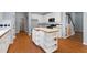 Spacious kitchen with a large island, wooden floors, and views of the staircase at 3362 Palm Nw Cir, Kennesaw, GA 30144