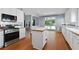 Bright kitchen features stainless steel appliances, wooden floors, and white cabinets at 3362 Palm Nw Cir, Kennesaw, GA 30144