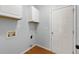 Clean laundry room with white cabinets and gray walls at 3362 Palm Nw Cir, Kennesaw, GA 30144