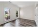 Bright, versatile room with laminate flooring, crown molding, and view of the front yard, ideal for an office or study at 3362 Palm Nw Cir, Kennesaw, GA 30144