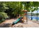 A charming community playground with a slide, nestled in a shaded area, providing a fun space for  at 3362 Palm Nw Cir, Kennesaw, GA 30144