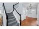 Elegant staircase with gray carpet and black and white railings, leading to the upper level of the home at 3362 Palm Nw Cir, Kennesaw, GA 30144