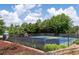 Well-maintained community tennis courts, fenced in and surrounded by mature trees and landscaping at 3362 Palm Nw Cir, Kennesaw, GA 30144