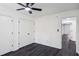 Bedroom features gray floors, a ceiling fan, two closets, and an entrance to another room at 5490 Chemin De Vie, Sandy Springs, GA 30342