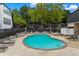 Community pool with lounge chairs, tables, and shade for residents to relax at 5490 Chemin De Vie, Sandy Springs, GA 30342