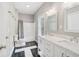 Bright bathroom features a double vanity with marble countertop and a shower-tub combination at 55 Rocky Ne Cir, White, GA 30184