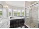 Spa-like bathroom featuring a soaking tub, a glass shower, and a double sink vanity at 55 Rocky Ne Cir, White, GA 30184