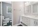 Bright bathroom features a double vanity with marble countertop and ample lighting at 55 Rocky Ne Cir, White, GA 30184