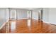 Light-filled bedroom features gleaming hardwood floors and ample windows, creating a bright and inviting space at 55 Rocky Ne Cir, White, GA 30184