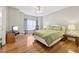 Comfortable bedroom with hardwood floors, a ceiling fan, and plenty of natural light at 55 Rocky Ne Cir, White, GA 30184