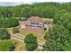 Elevated view of the home, highlighting its private setting and lush landscaping at 55 Rocky Ne Cir, White, GA 30184