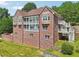 Brick home with multi-level decks and outdoor access, complete with lush landscaping and curb appeal at 55 Rocky Ne Cir, White, GA 30184