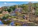 Lake view property featuring stairs leading to the water, and lush, mature trees at 55 Rocky Ne Cir, White, GA 30184
