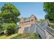 Inviting brick home with multi-level decks and stairs, offering stunning outdoor living spaces at 55 Rocky Ne Cir, White, GA 30184