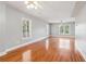 Bright living room with gleaming hardwood floors and multiple windows at 55 Rocky Ne Cir, White, GA 30184