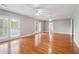 Spacious living room boasts gleaming hardwood floors and multiple ceiling fans at 55 Rocky Ne Cir, White, GA 30184