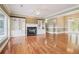 Spacious living area featuring hardwood flooring, built-in bookshelves, and modern lighting at 55 Rocky Ne Cir, White, GA 30184