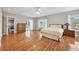 Spacious primary bedroom features hardwood floors, ample lighting, and access to a private balcony at 55 Rocky Ne Cir, White, GA 30184