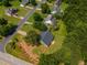 Aerial view of a green home with lush trees, located in a well-developed neighborhood at 10 Stewart Hollow Ln, Covington, GA 30016