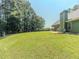Lush backyard featuring a spacious lawn and mature trees, perfect for outdoor activities at 10 Stewart Hollow Ln, Covington, GA 30016
