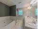 Bright bathroom featuring a soaking tub, shower, and double sink vanity with updated fixtures at 10 Stewart Hollow Ln, Covington, GA 30016