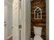 Half bathroom with rustic wood accent wall, farmhouse decor, and modern fixtures, creating a cozy atmosphere at 10 Stewart Hollow Ln, Covington, GA 30016