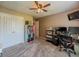 Well-lit bedroom with neutral walls, neutral carpet, a ceiling fan, and a large closet at 10 Stewart Hollow Ln, Covington, GA 30016