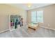 Neutral bedroom featuring a large window and neutral carpet at 10 Stewart Hollow Ln, Covington, GA 30016