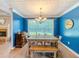 Cozy dining area with blue walls, wood flooring, and a view of the fireplace at 10 Stewart Hollow Ln, Covington, GA 30016
