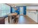 Dining area with a long wooden table, hardwood floors, and ample natural light at 10 Stewart Hollow Ln, Covington, GA 30016