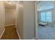 Hallway leading to a bright bedroom with large window with neutral carpet at 10 Stewart Hollow Ln, Covington, GA 30016