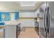Well-lit kitchen showcases stainless steel appliances, white cabinetry, breakfast bar and wood-look tile flooring at 10 Stewart Hollow Ln, Covington, GA 30016