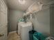Functional laundry room with a side-by-side washer and dryer, shelving, and storage baskets at 10 Stewart Hollow Ln, Covington, GA 30016