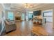 Bright living room featuring a brick fireplace and hardwood flooring at 10 Stewart Hollow Ln, Covington, GA 30016