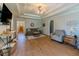 Open living room with a tray ceiling and hardwood flooring at 10 Stewart Hollow Ln, Covington, GA 30016