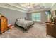 Spacious main bedroom featuring a tray ceiling, ceiling fan, and neutral decor, creating a serene retreat at 10 Stewart Hollow Ln, Covington, GA 30016