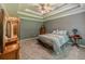 Comfortable main bedroom with tray ceiling, ceiling fan, neutral decor, and dresser, offers a relaxing space at 10 Stewart Hollow Ln, Covington, GA 30016