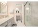 Bright bathroom featuring a shower with glass doors, a vanity with sink, and a connecting bathroom at 1310 Chilton Woods Rd, Rutledge, GA 30663