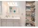 Bathroom vanity with sink, storage, and mirror with open shelving for storage at 1310 Chilton Woods Rd, Rutledge, GA 30663