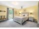 Bedroom with yellow walls and a full bed with nightstands and large windows at 1310 Chilton Woods Rd, Rutledge, GA 30663