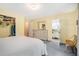 Bedroom with yellow walls leading into a white bathroom and a walk-in closet at 1310 Chilton Woods Rd, Rutledge, GA 30663