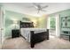 Bedroom with green walls, plush carpet, and a queen bed with nightstands at 1310 Chilton Woods Rd, Rutledge, GA 30663
