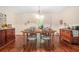 Formal dining room with wooden table, metal chairs, wood floors, and ornate decorations at 1310 Chilton Woods Rd, Rutledge, GA 30663