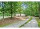 Scenic view of a long, mossy driveway leading to a brick home surrounded by lush trees at 1310 Chilton Woods Rd, Rutledge, GA 30663