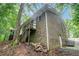 Two-story brick home with an exterior staircase and surrounding greenery at 1310 Chilton Woods Rd, Rutledge, GA 30663