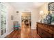 Inviting foyer with hardwood floors, decorative chair, and a view into the living room at 1310 Chilton Woods Rd, Rutledge, GA 30663