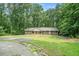 Beautiful ranch-style brick home with green lawn, walkway, and mature trees around the property at 1310 Chilton Woods Rd, Rutledge, GA 30663