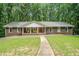 Ranch style home with red brick, white columns, walkway, and a well-manicured lawn at 1310 Chilton Woods Rd, Rutledge, GA 30663